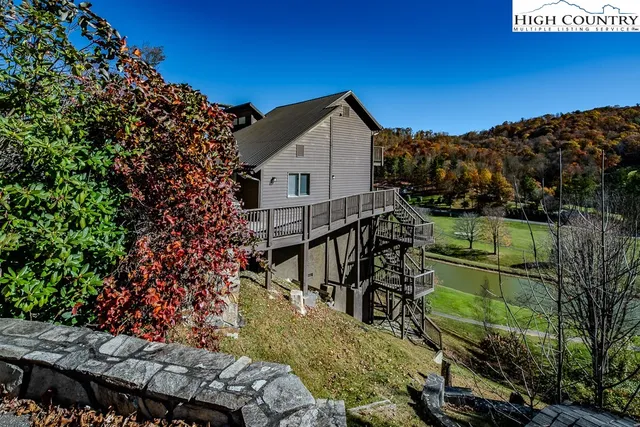 a view of a house with a yard and sitting area