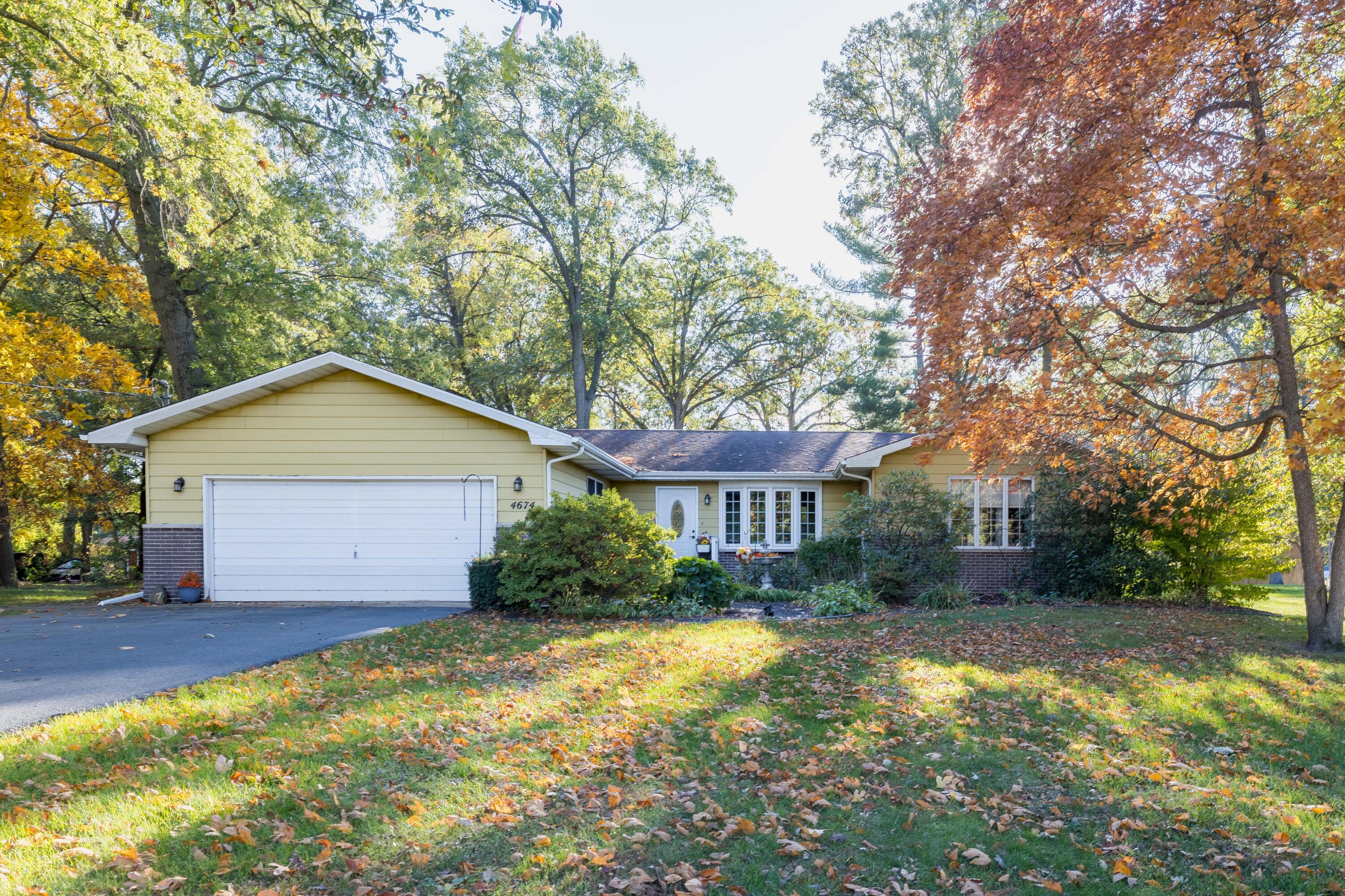 a view of backyard of house with green space