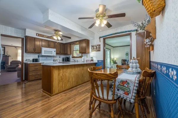 a view of a dining room with furniture and wooden floor