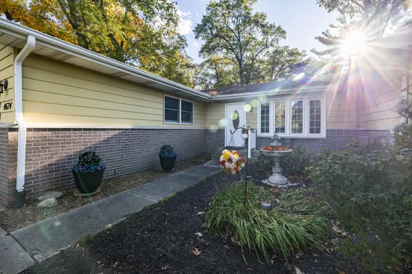 a backyard of a house with yard and outdoor seating