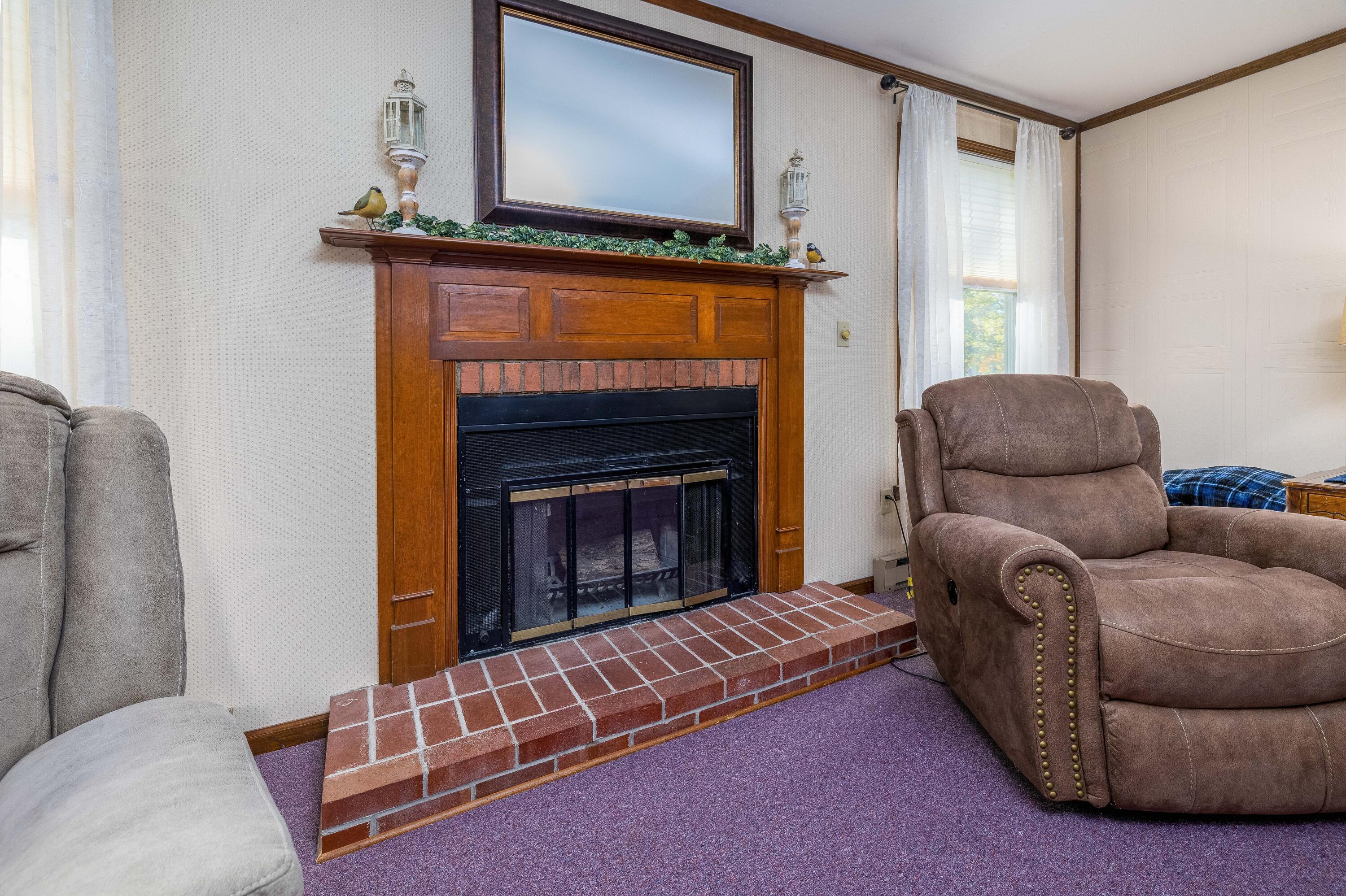 4674 Friar Tuck Circle Rensselaer, IN 47978 - Photo 18 of 47 a living room with furniture and a fireplace