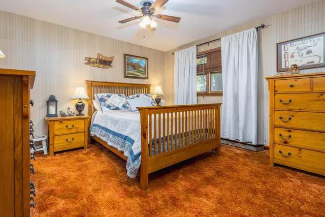 a bed room with a bed and a window