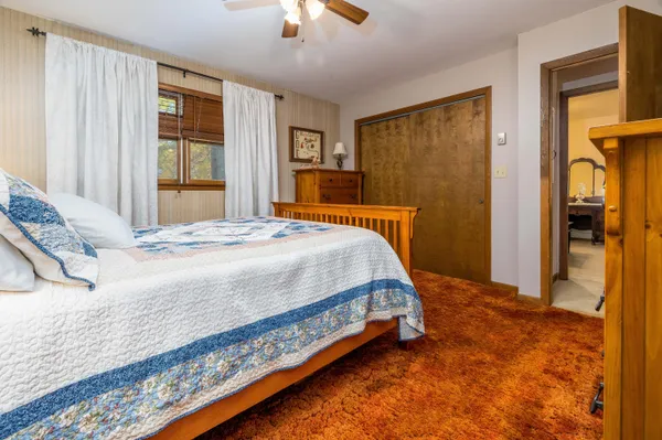 a bedroom with a bed and a dresser