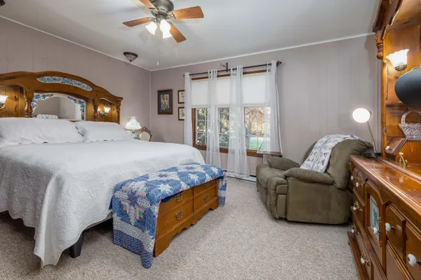 a bedroom with a bed couch and window