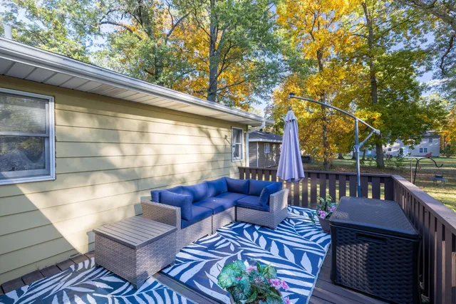 a view of a patio with couches table and chairs and potted plants