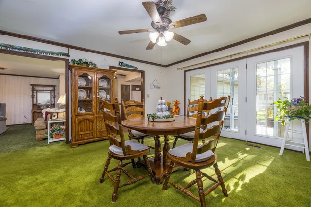 a view of a dining room with furniture and a chandelier