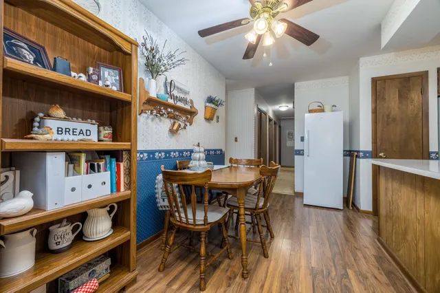 a dining area with furniture and wooden floor