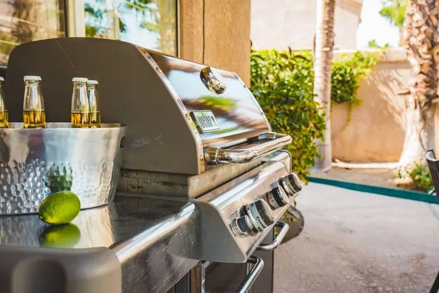 a living room with furniture a large window and a fireplace