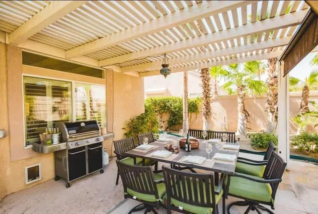 a living room with furniture kitchen view and a large window