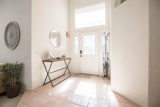 a living room with furniture and a piano
