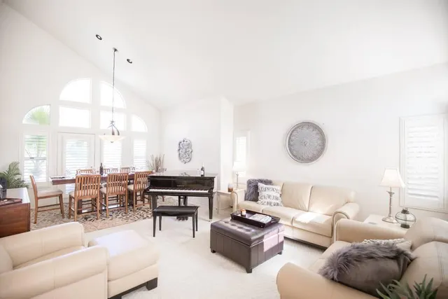 a dining room with furniture and a large window
