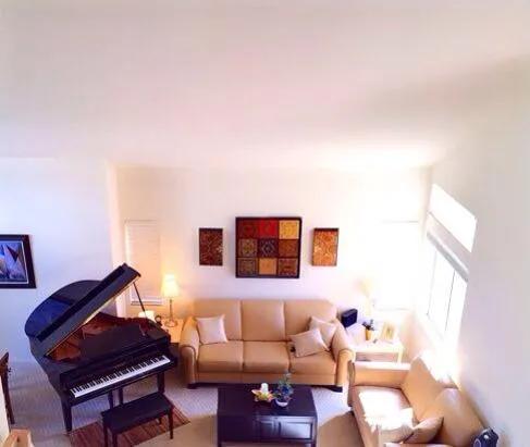 a kitchen with white cabinets and refrigerator