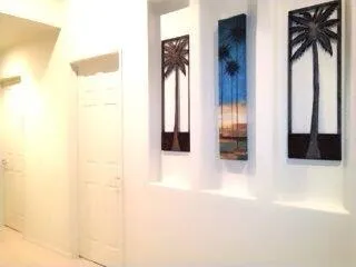 a living room with furniture kitchen area and a large window