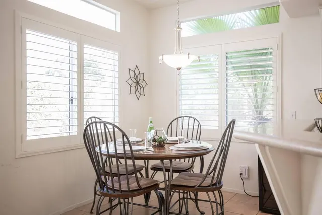 a spacious bathroom with a double vanity sink bathtub and next to a window