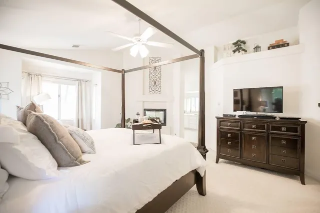 a bedroom with a bed and a night stand