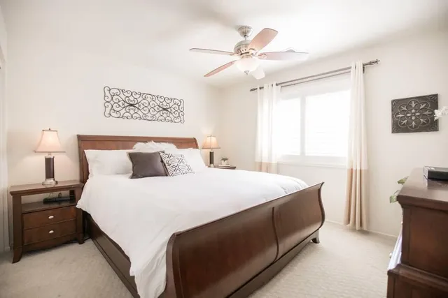 a bedroom with a large bed and a chandelier