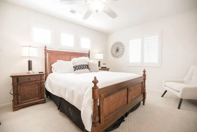 a bedroom with a bed a desk and chair