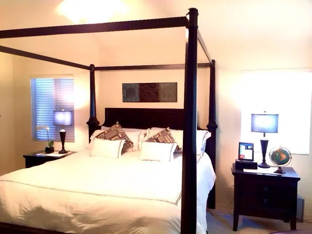 a bedroom with a bed and a window