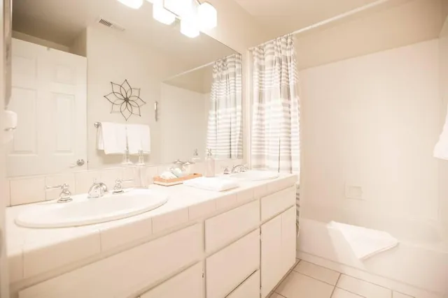 a bedroom with a bed and a night stand