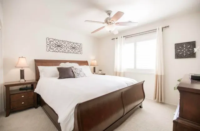 a bedroom with a bed and a flat screen tv