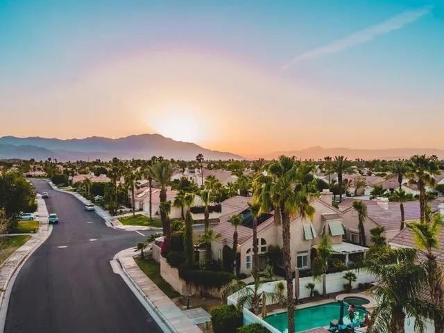 an aerial view of a house with garden space and street view