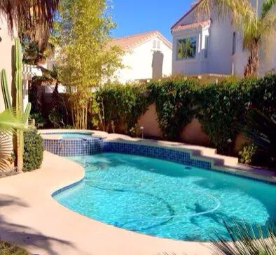 a front view of a house with a yard and fountain