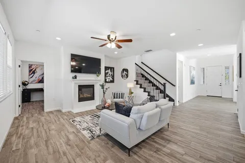 a living room with furniture a fireplace and a flat screen tv
