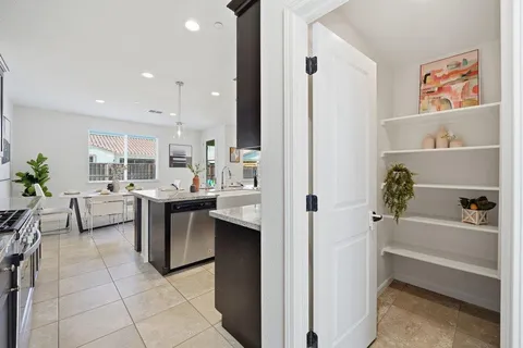 a view of kitchen with furniture and refrigerator