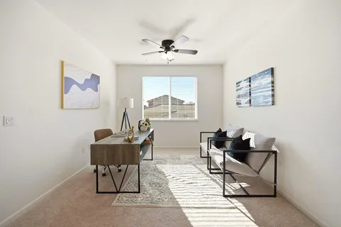 a work room with furniture and a window