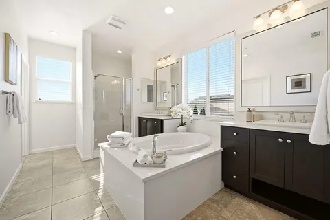 a spacious bathroom with a sink double vanity and a shower