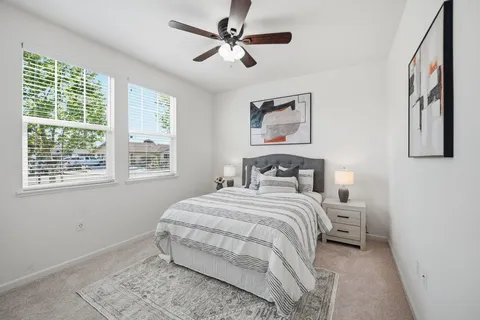 a bedroom with a bed and a window