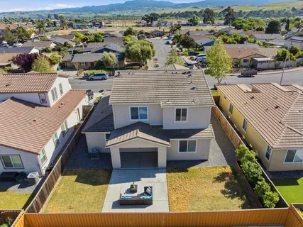 an aerial view of a house with a yard
