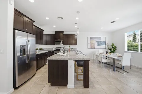 a kitchen with kitchen island a sink stainless steel appliances and cabinets