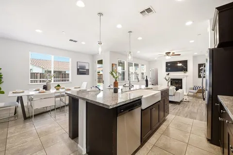 a kitchen with sink stove and cabinets