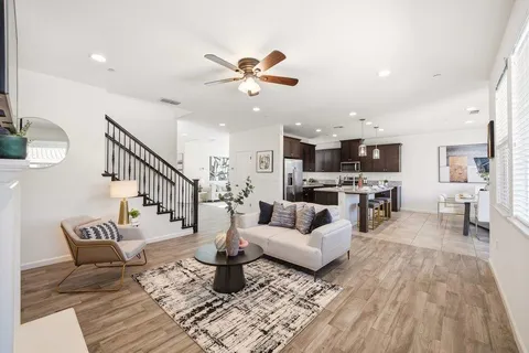 a living room with furniture and kitchen view