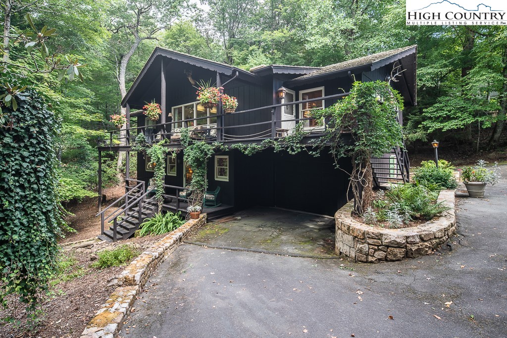 a house with a yard and potted plants
