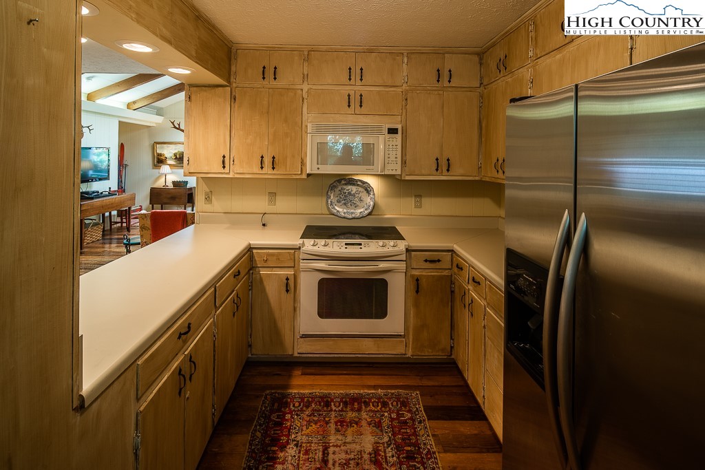 356 Balsam Road Boone, NC 28607 - Photo 15 of 37 a kitchen with stainless steel appliances granite countertop a stove a refrigerator and a cabinets