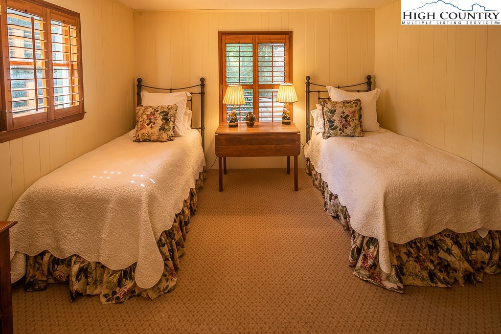 356 Balsam Road Boone, NC 28607 - Photo 17 of 37 a bedroom with a bed and wooden floor