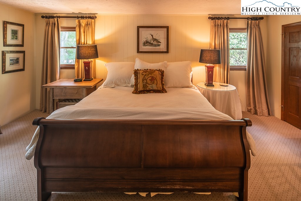 356 Balsam Road Boone, NC 28607 - Photo 19 of 37 a bedroom with a bed and wooden floor