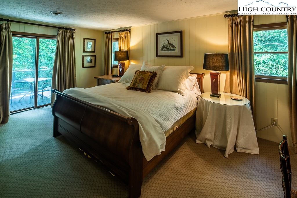 356 Balsam Road Boone, NC 28607 - Photo 20 of 37 a bed sitting in a bedroom next to a window