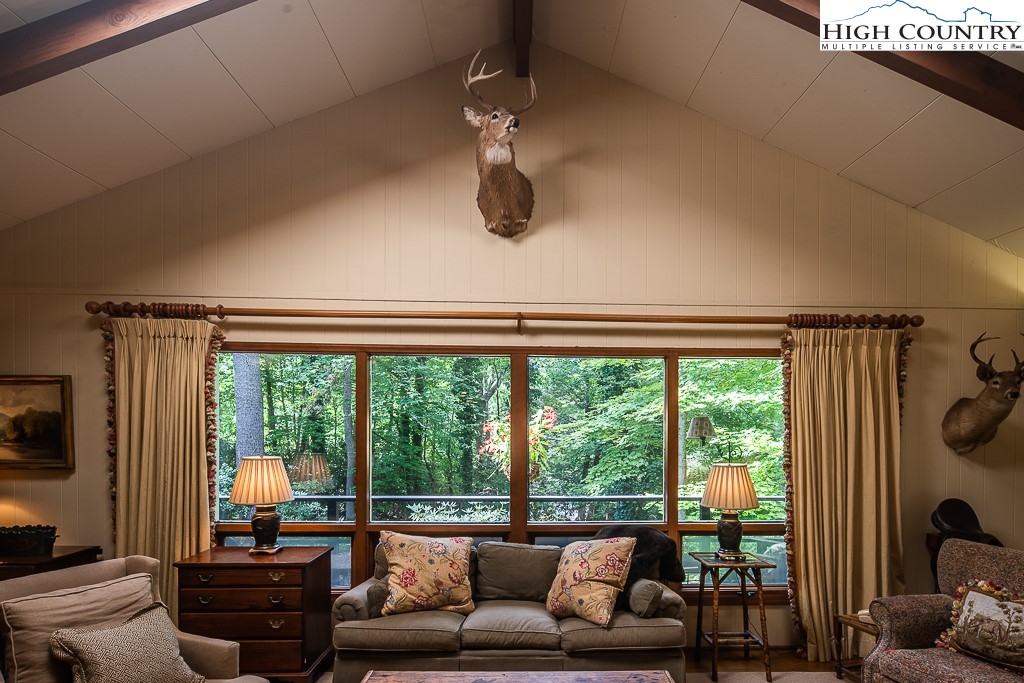 356 Balsam Road Boone, NC 28607 - Photo 5 of 37 a living room with furniture and a floor to ceiling window