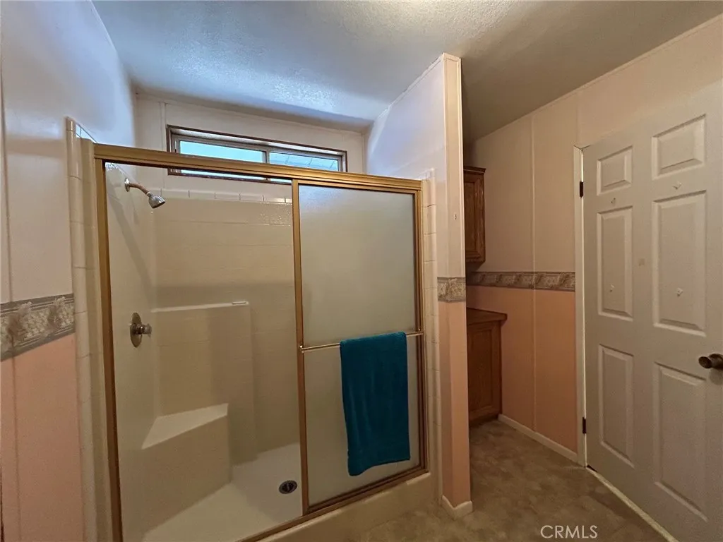 27250 Murrieta Road, Unit 347 Menifee, CA 92586 - Photo 19 of 38 a bathroom with a glass shower door and a sink