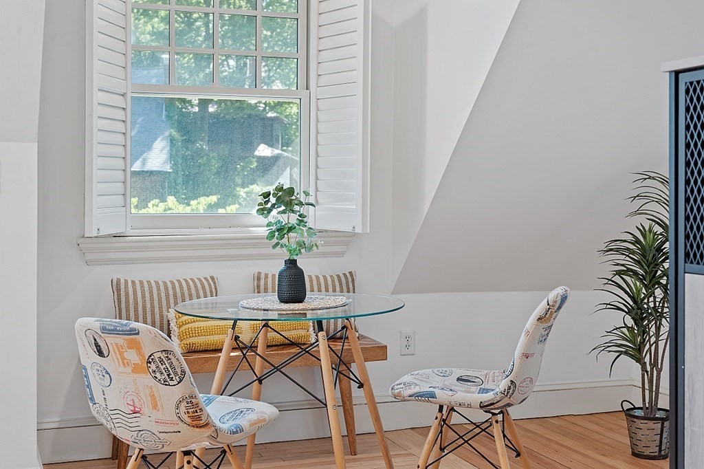 2 Gardner Road, Unit 3 Brookline, MA 02445 - Photo 11 of 32 a dining room with furniture wooden floor and a chandelier