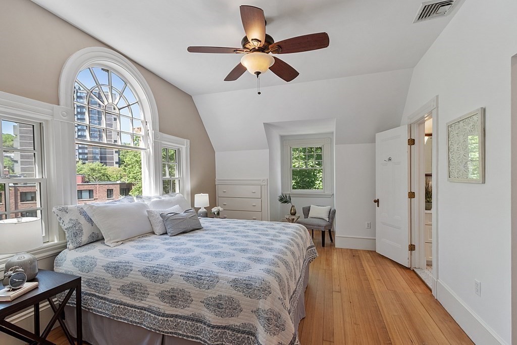 2 Gardner Road, Unit 3 Brookline, MA 02445 - Photo 14 of 32 a bedroom with a bed and a chandelier