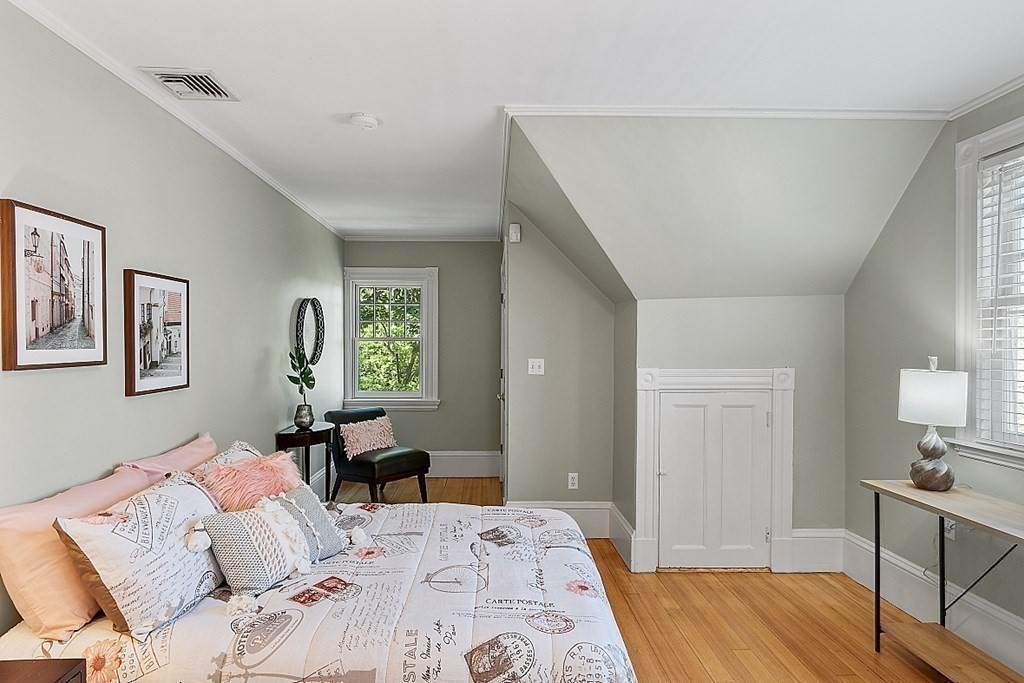 2 Gardner Road, Unit 3 Brookline, MA 02445 - Photo 19 of 32 a bedroom with a bed and wooden floor