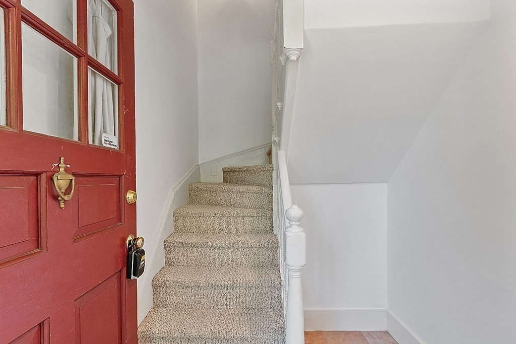 2 Gardner Road, Unit 3 Brookline, MA 02445 - Photo 23 of 32 a view of staircase with white walls and a window