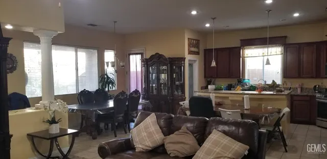 a living room with fireplace furniture and a chandelier