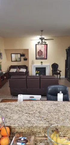 a kitchen with sink a refrigerator and wooden cabinets