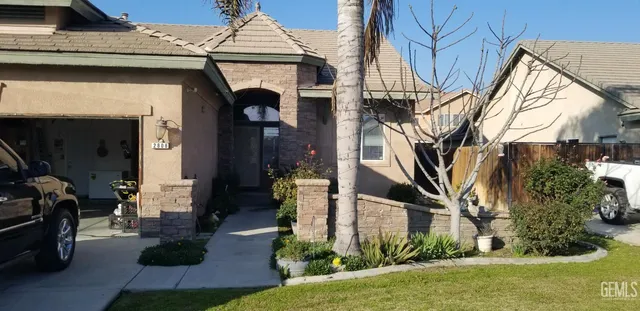 a front view of a house with garden