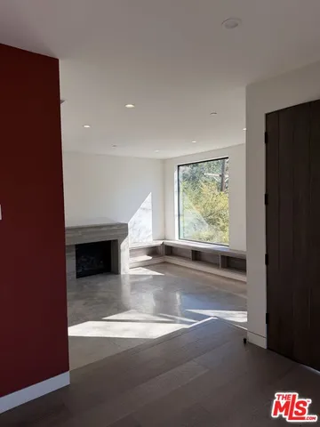 a view of livingroom with furniture large window and front door